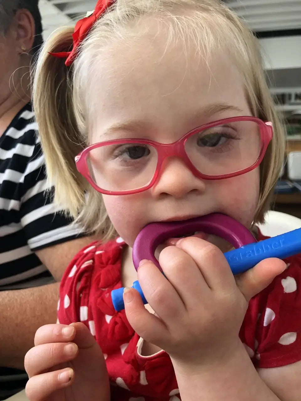 A young girl loving the oral input from a chewable toy from Starfish