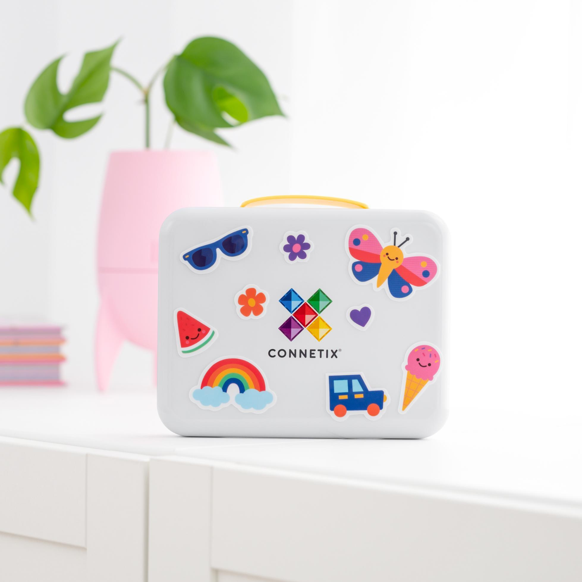 The Connetix Tiles - Travel Mini Pack 32pc pictured on a white table with a green plant in the background