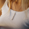 Star &amp; Co Anxiety Jewellery - The Flor Necklace worn on a girl with a white top