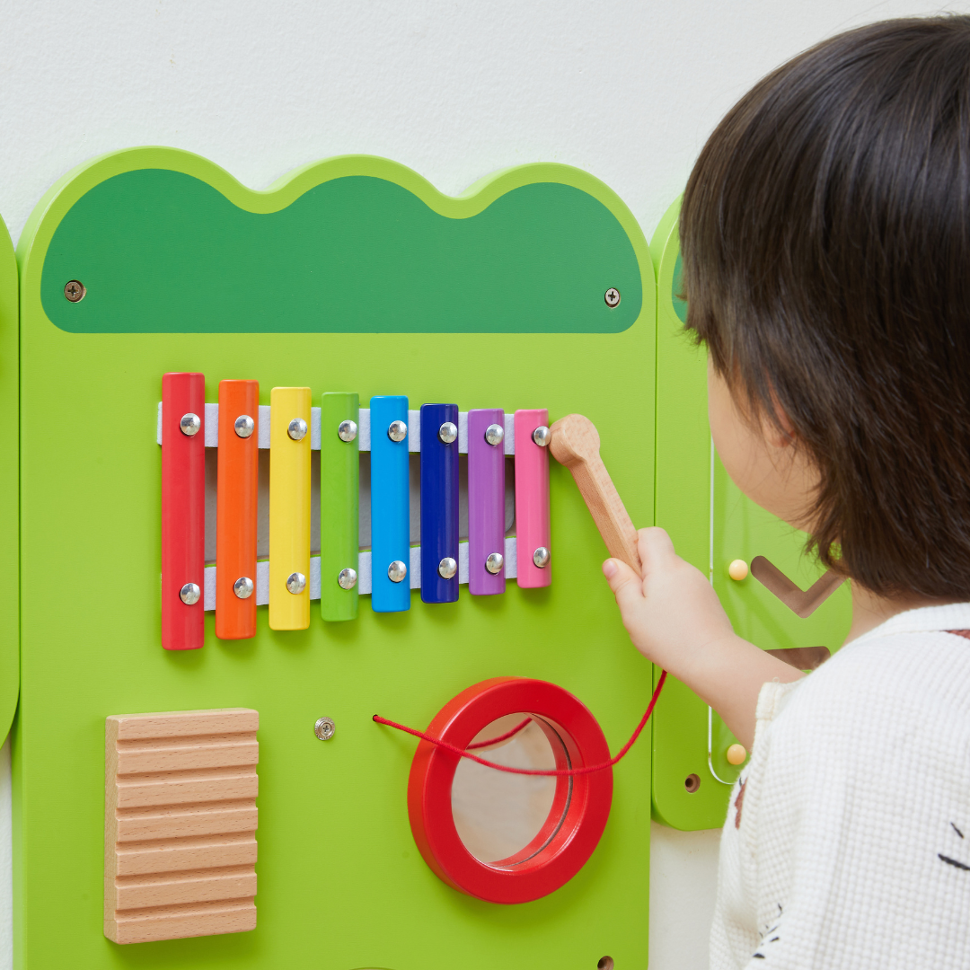A young boy playing with the VIGA Interactive Wall Mural Junior Crocodile
