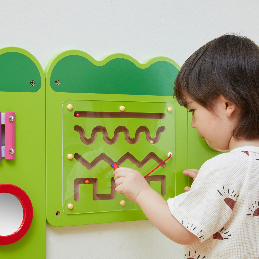 a young boy playing with the VIGA Interactive Wall Mural Junior Crocodile