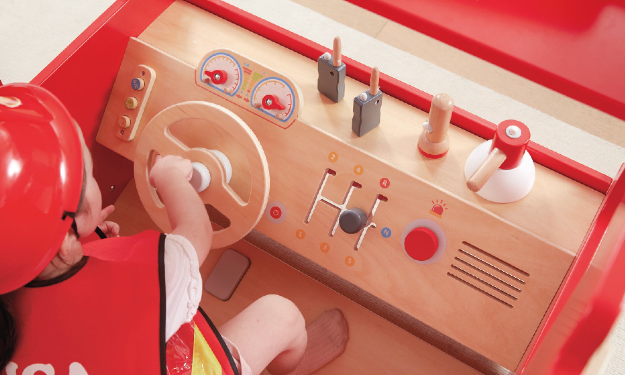 A young girl playing in the Viga Super Fire Engine Set