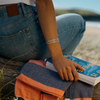 a person sitting down at the beach and wearing the Star &amp; Co Anxiety Jewellery - The Winda Bracelet