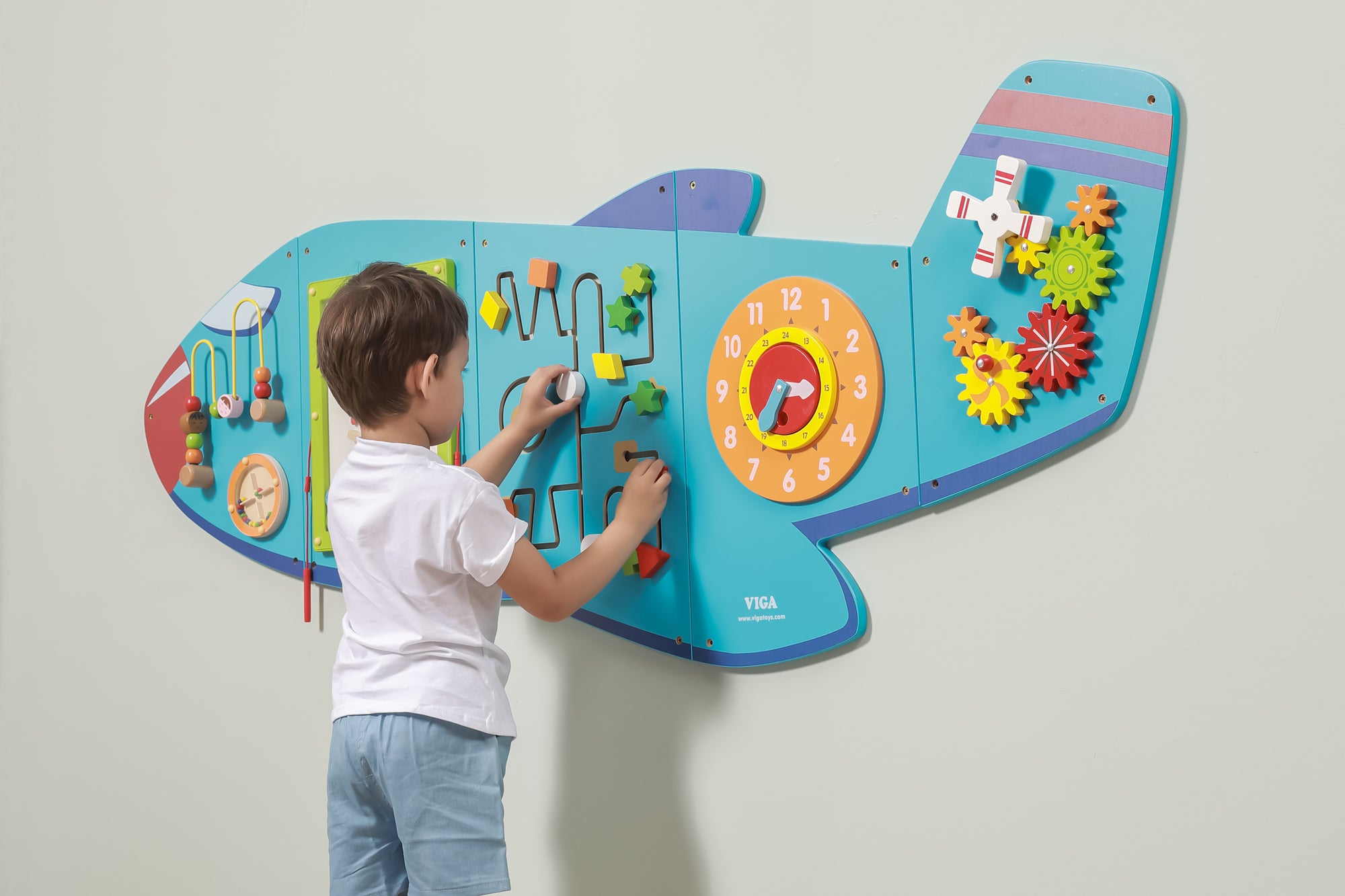 A young boy playing with the VIGA Interactive Wall Mural Plane