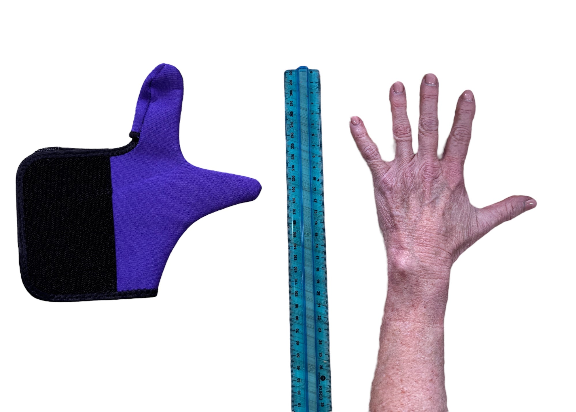 Purple and black Adaptive Chewy Gloves next to a ruler and a hand on a white background