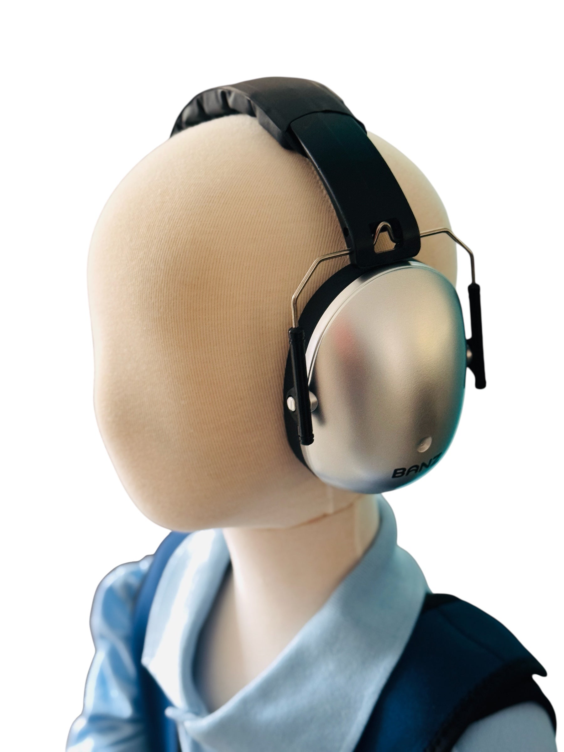 Mannequin head wearing a pair of Banz Kids Earmuffs - Silver on a white background