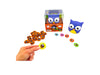Blue Orange Hoot or Toot on display with all tokens in front of box and a hand holding a yellow token