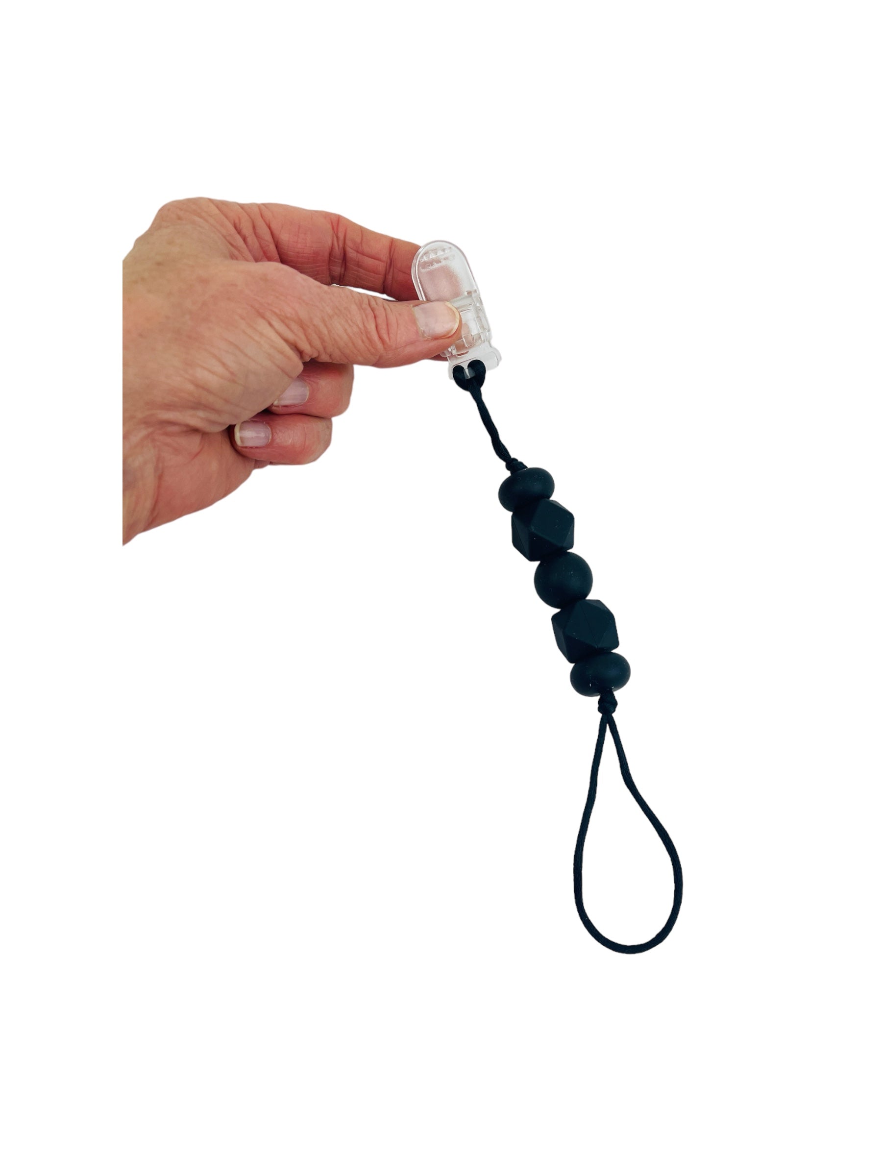 a hand holding the black Chewy Charms Chewy Loop Shirt Saver - Clip On