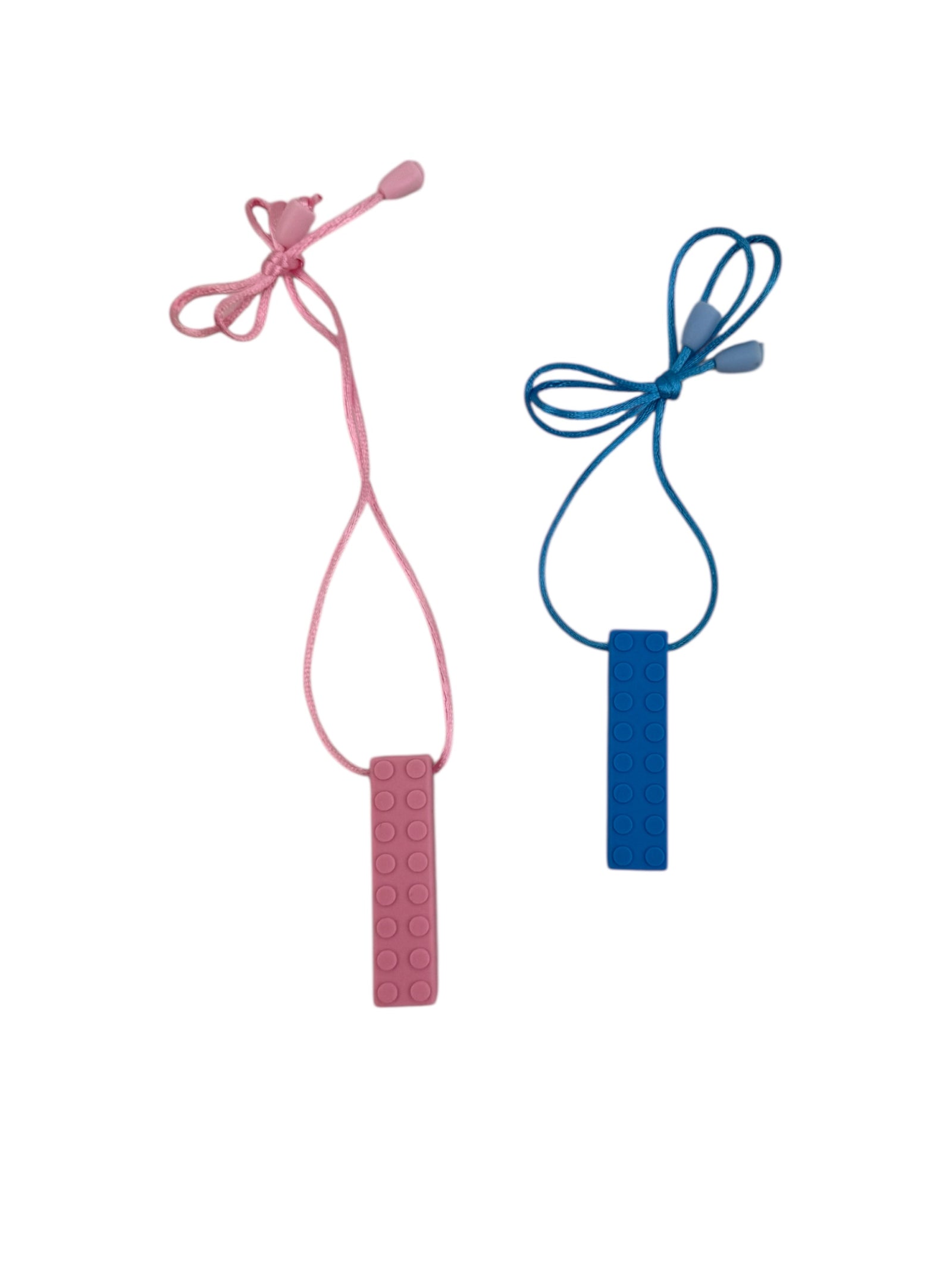 The pink and blue Chewy Charms Necklace Chew - Bricks pictured together on a white background