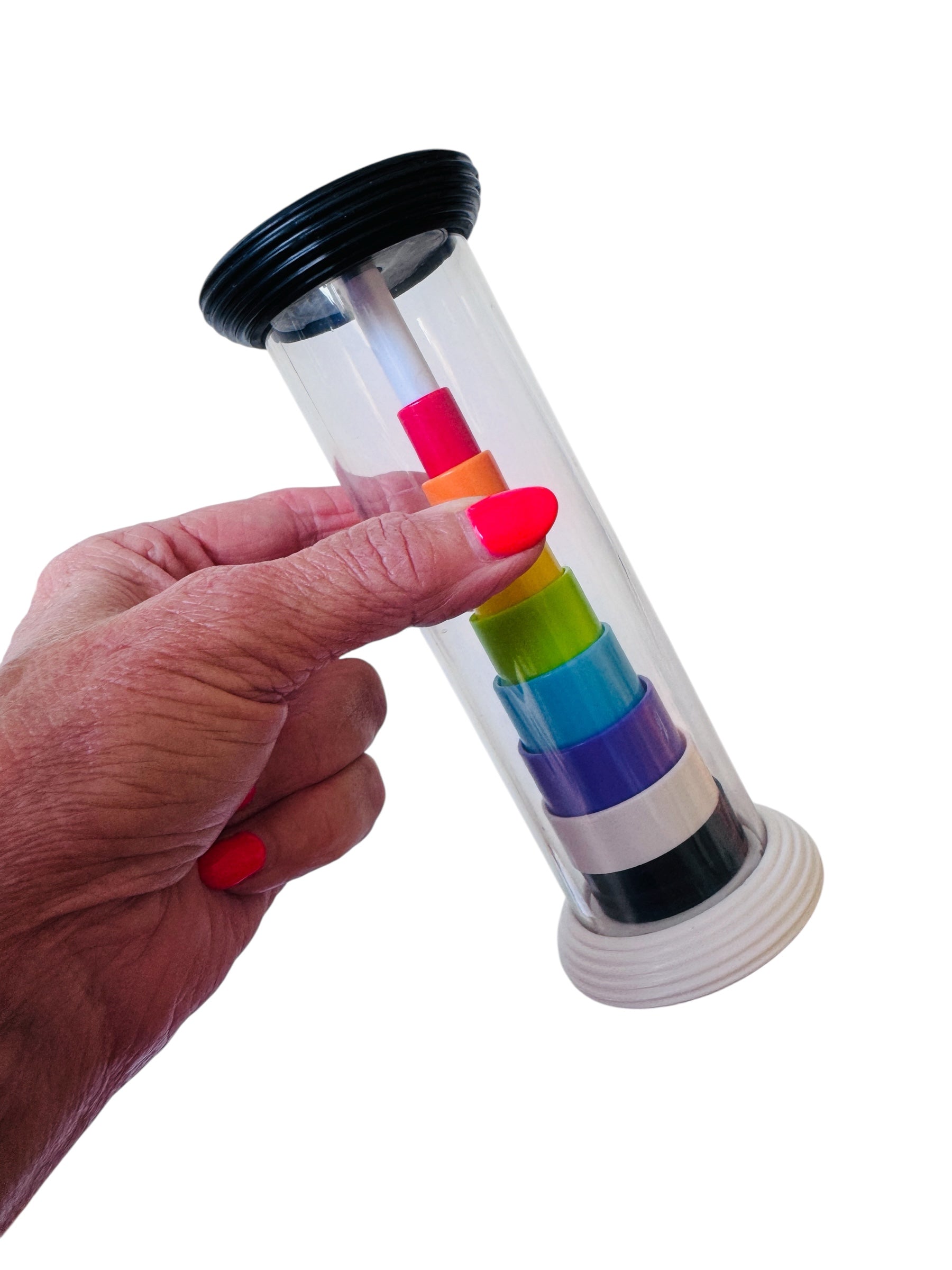 A hand holding the Fat Brain Flipty pictured on a white background