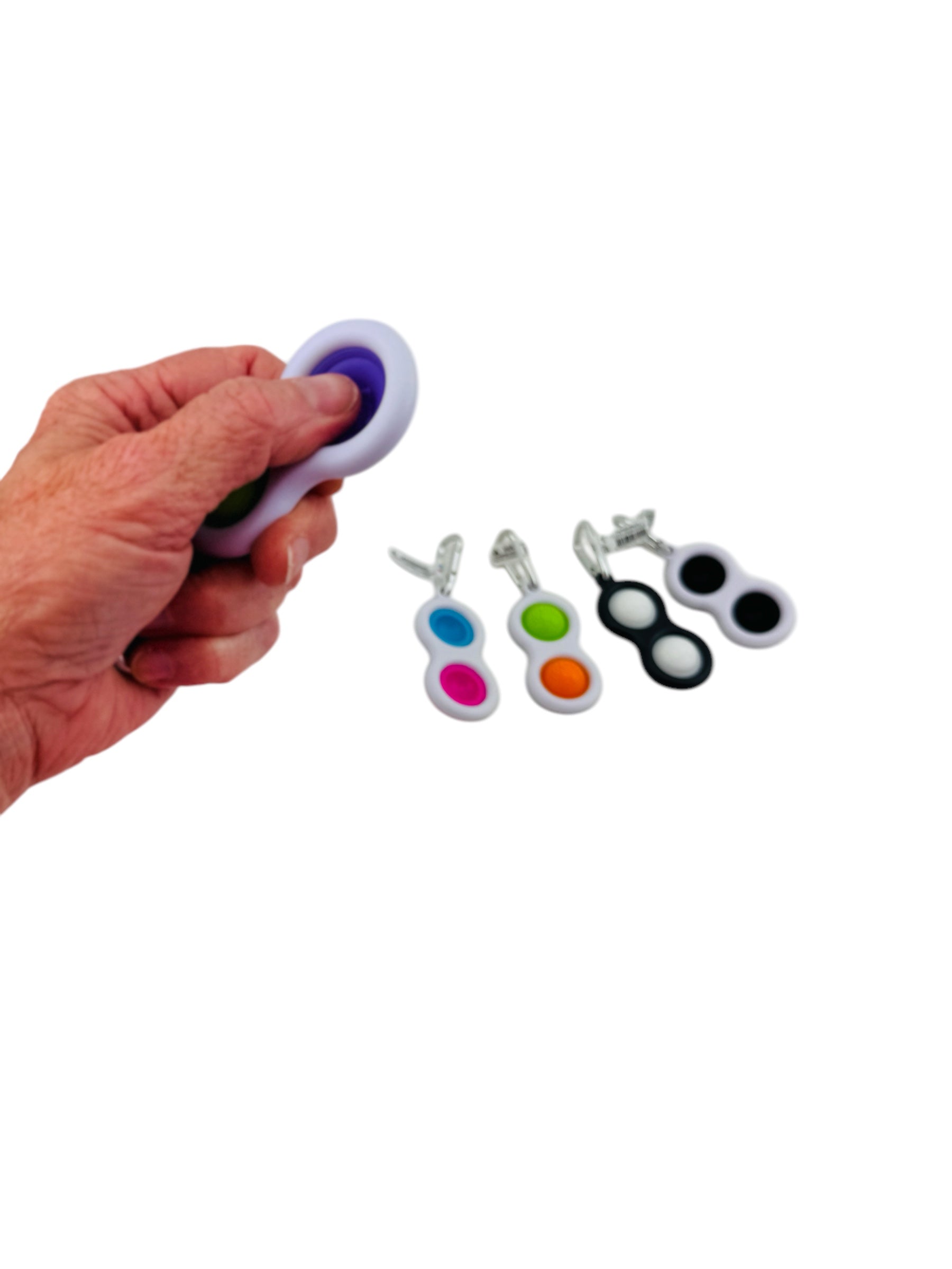 a hand holding the purple Fat Brain Simpl Dimpl Fidget