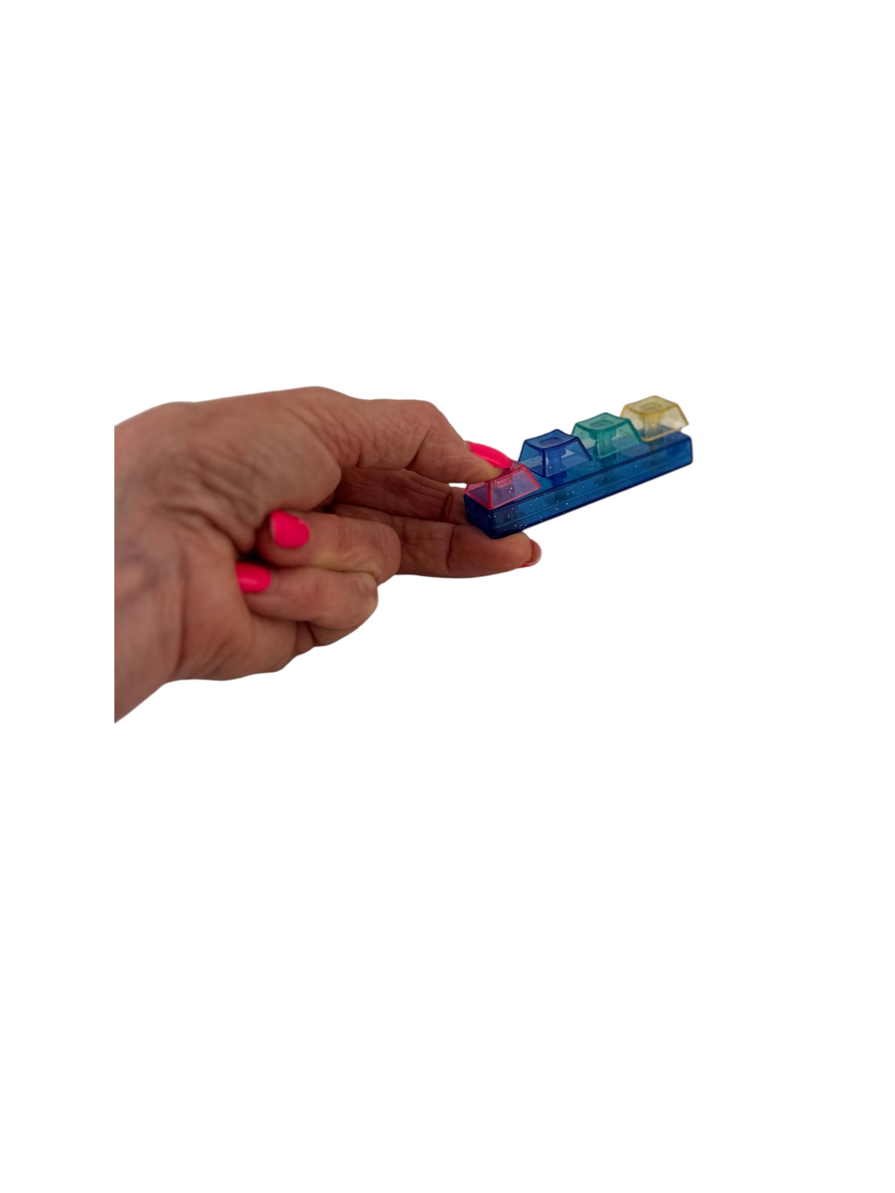 a hand holding the Fidget Fingers Keyboard Click Keyring