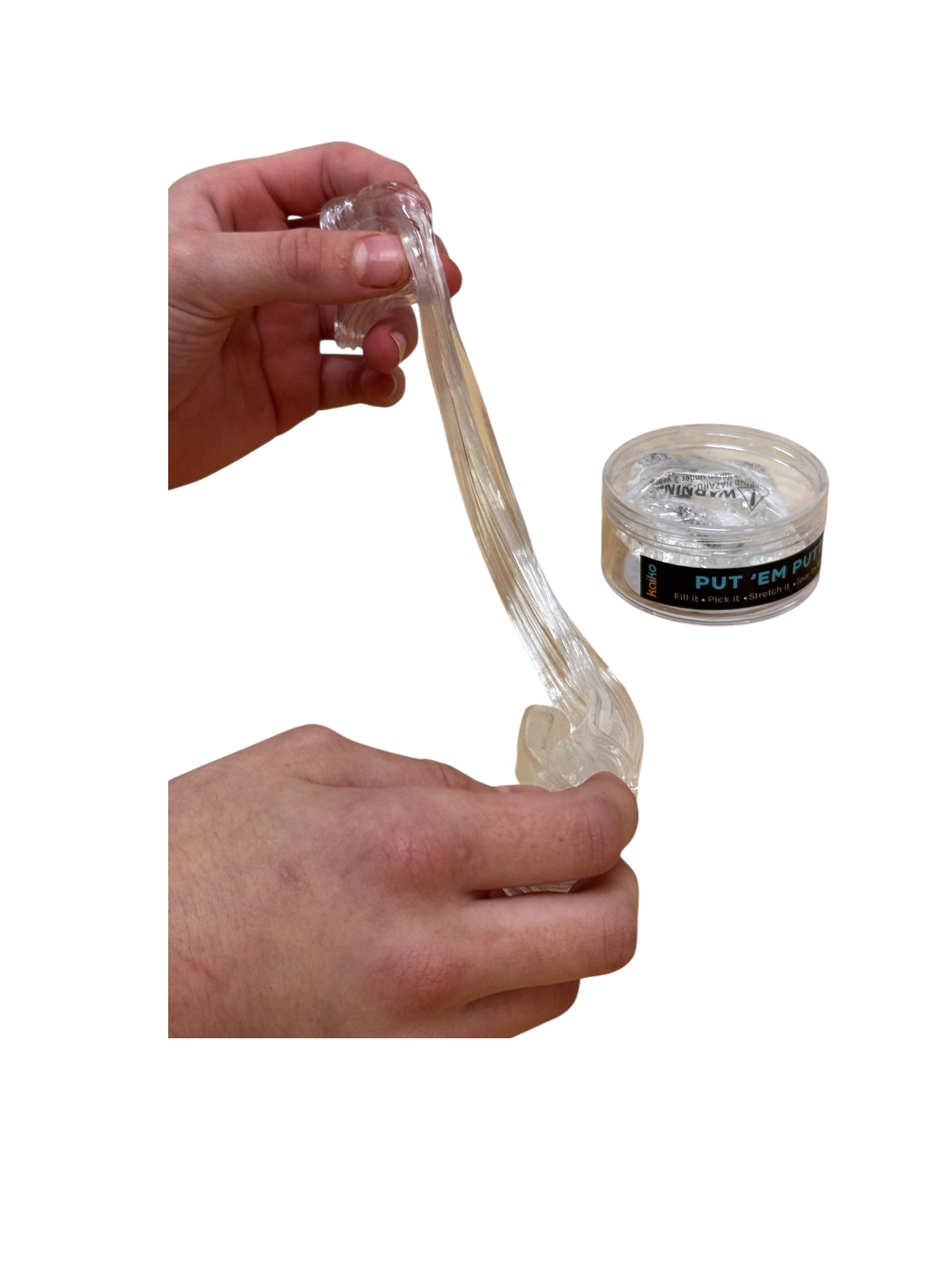 Hand holding Kaiko Put &quot;Em Putty with a container of putty on a white background