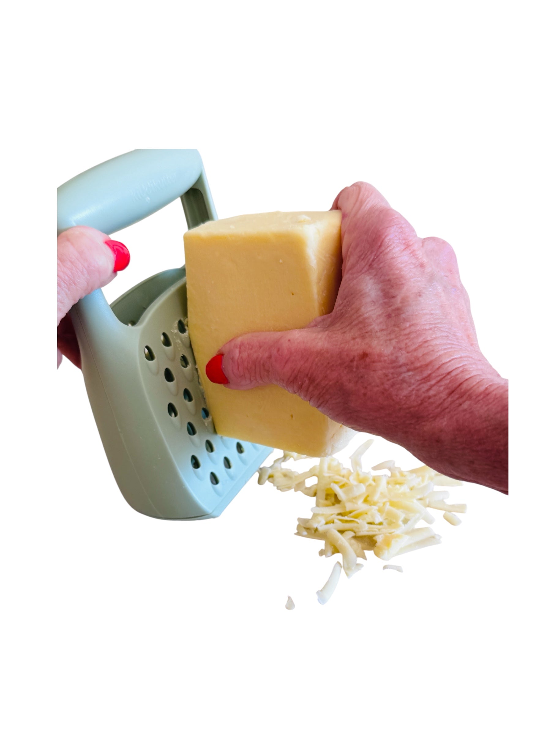A hand grating cheese on the Kiddikutter Safety Grater