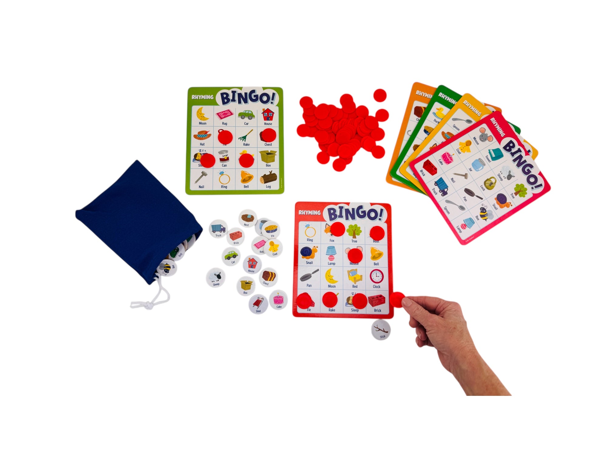 Peaceable Kingdom Rhyming Bingo set with cards, markers, and a bag on a white background
