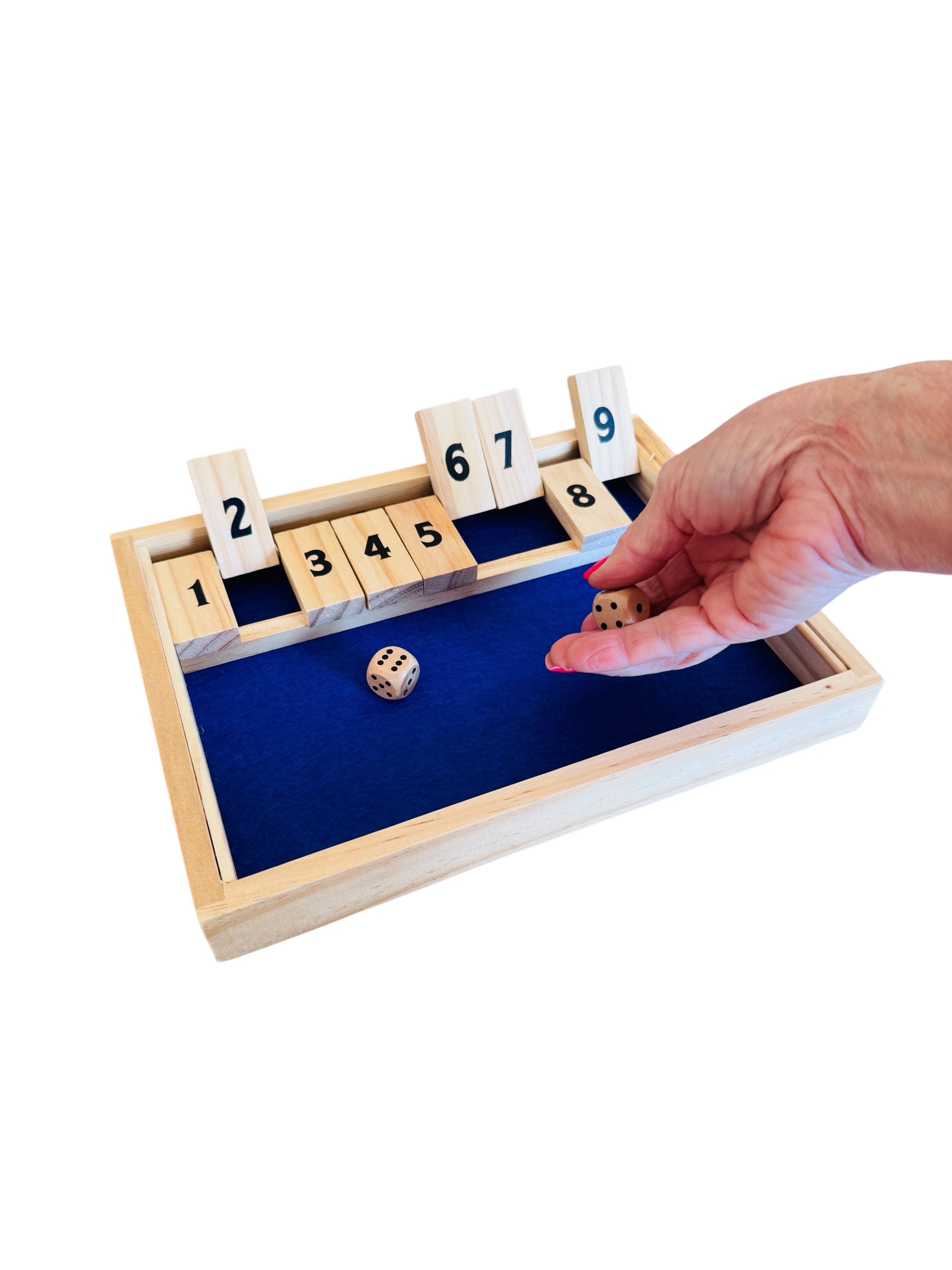 A person playing the Shut the Box game