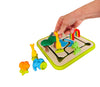 a hand placing the yellow girafe on the Smart Games Safari Park Jr game board