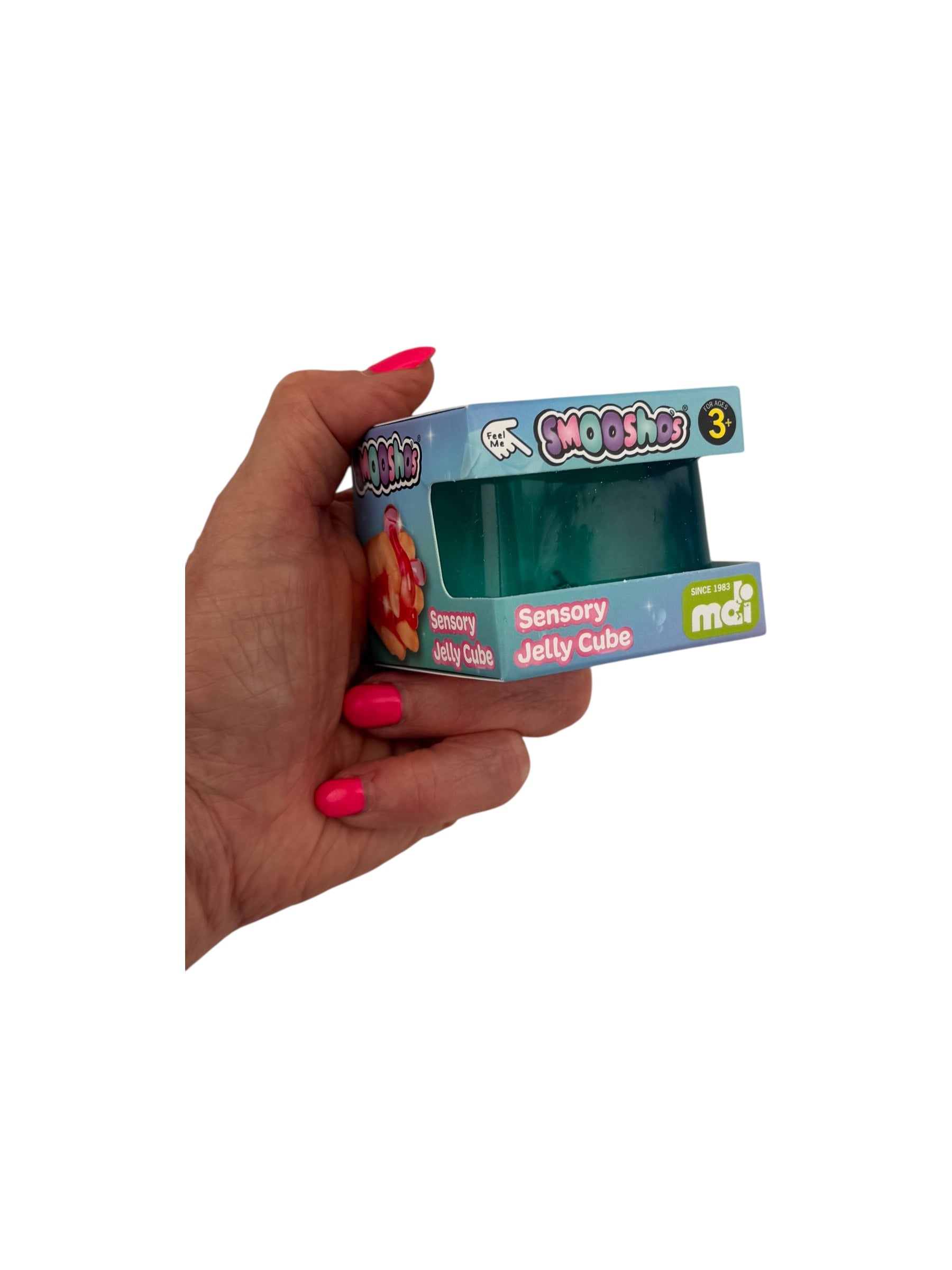 a hand holding the blue Smooshos Jelly Stress Cube in it&#39;s packaging