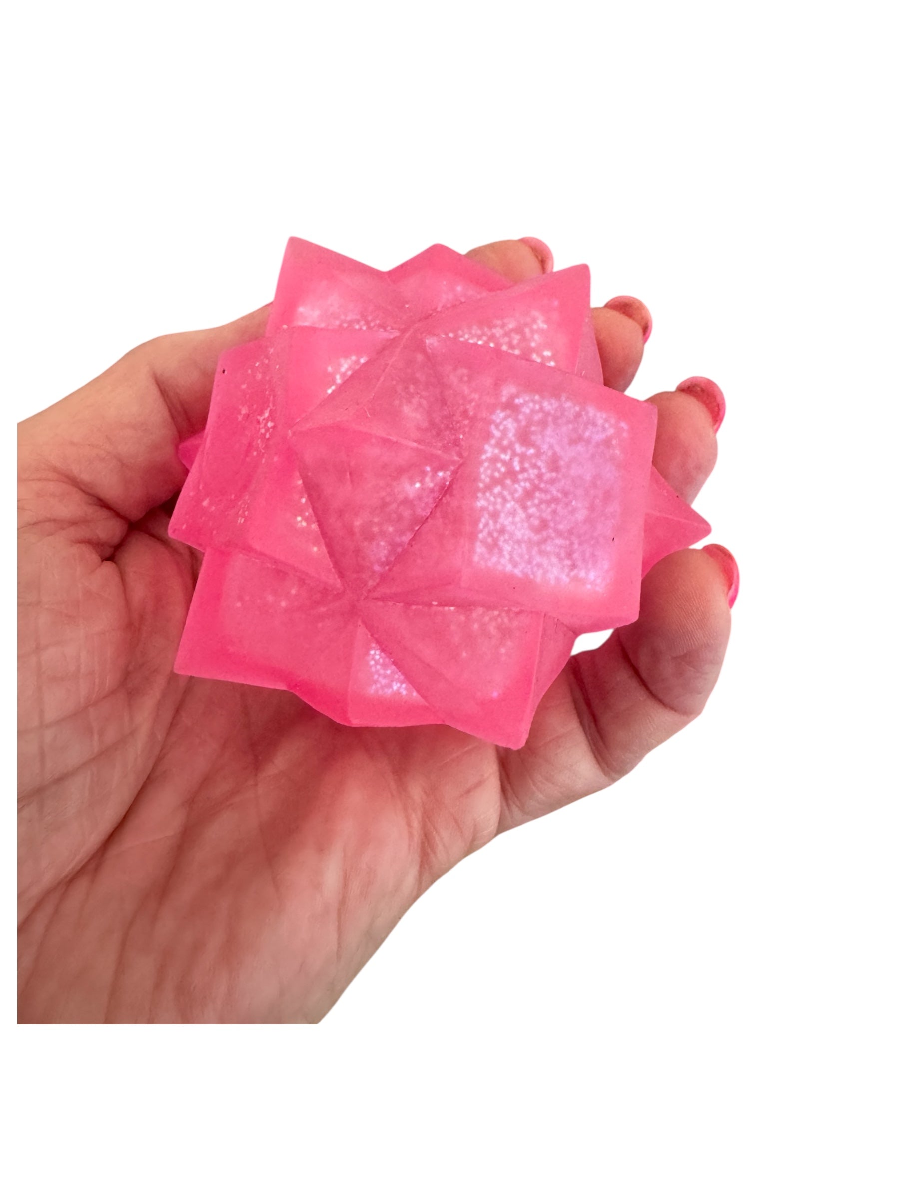 A hand holding the pink Smooshos Super Squeeze - Starburst