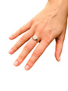 a hand wearing the Star &amp; Co Anxiety Jewellery - The Ellie Ring on a white background