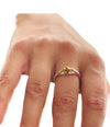 a hand wearing the Star &amp; Co Anxiety Jewellery - The India Ring on a white background