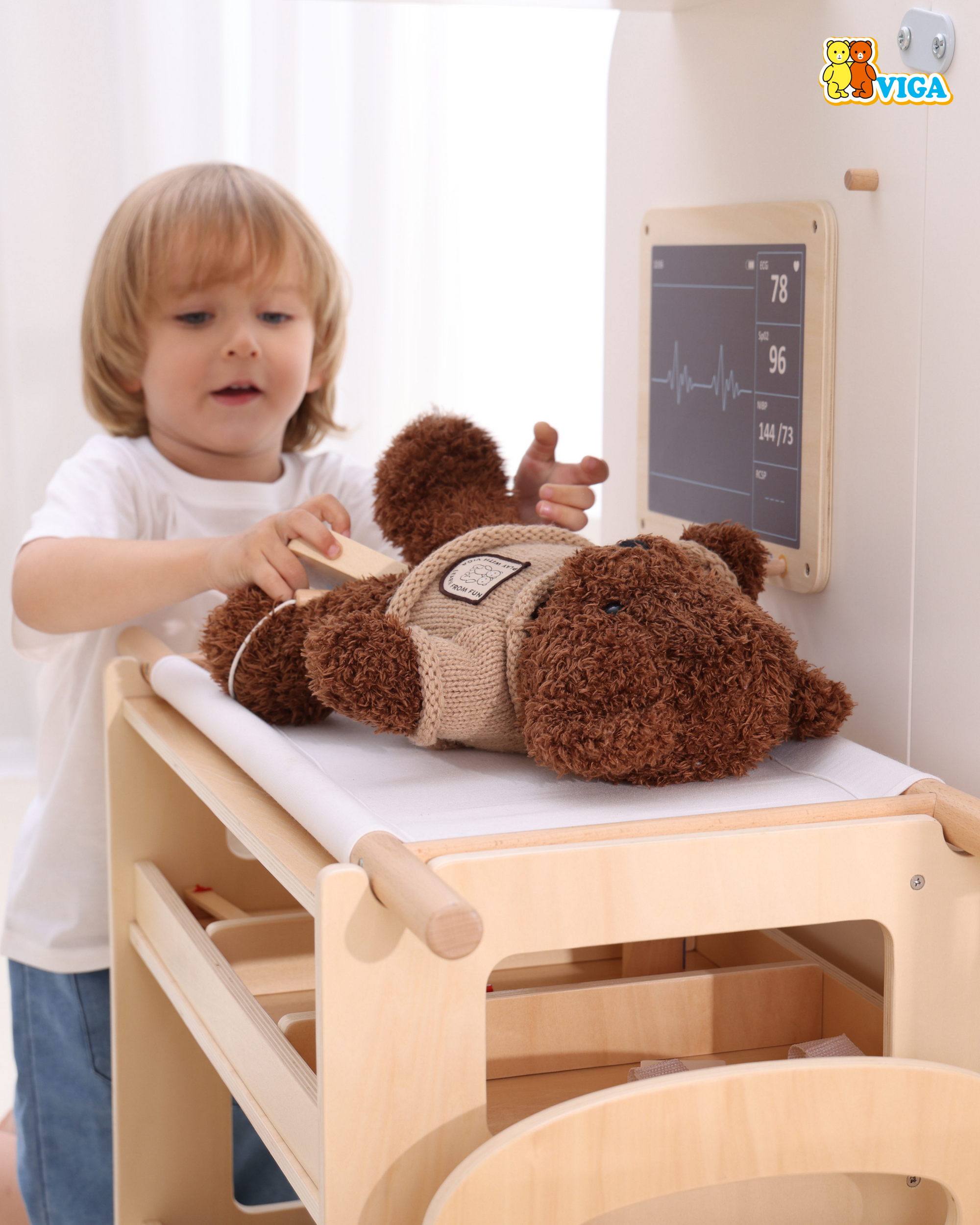 A young boy pretend playing in the Viga Super Ambulance Set