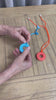 a video demonstration of the Chewy Charms Necklace Chew - Donut Mini