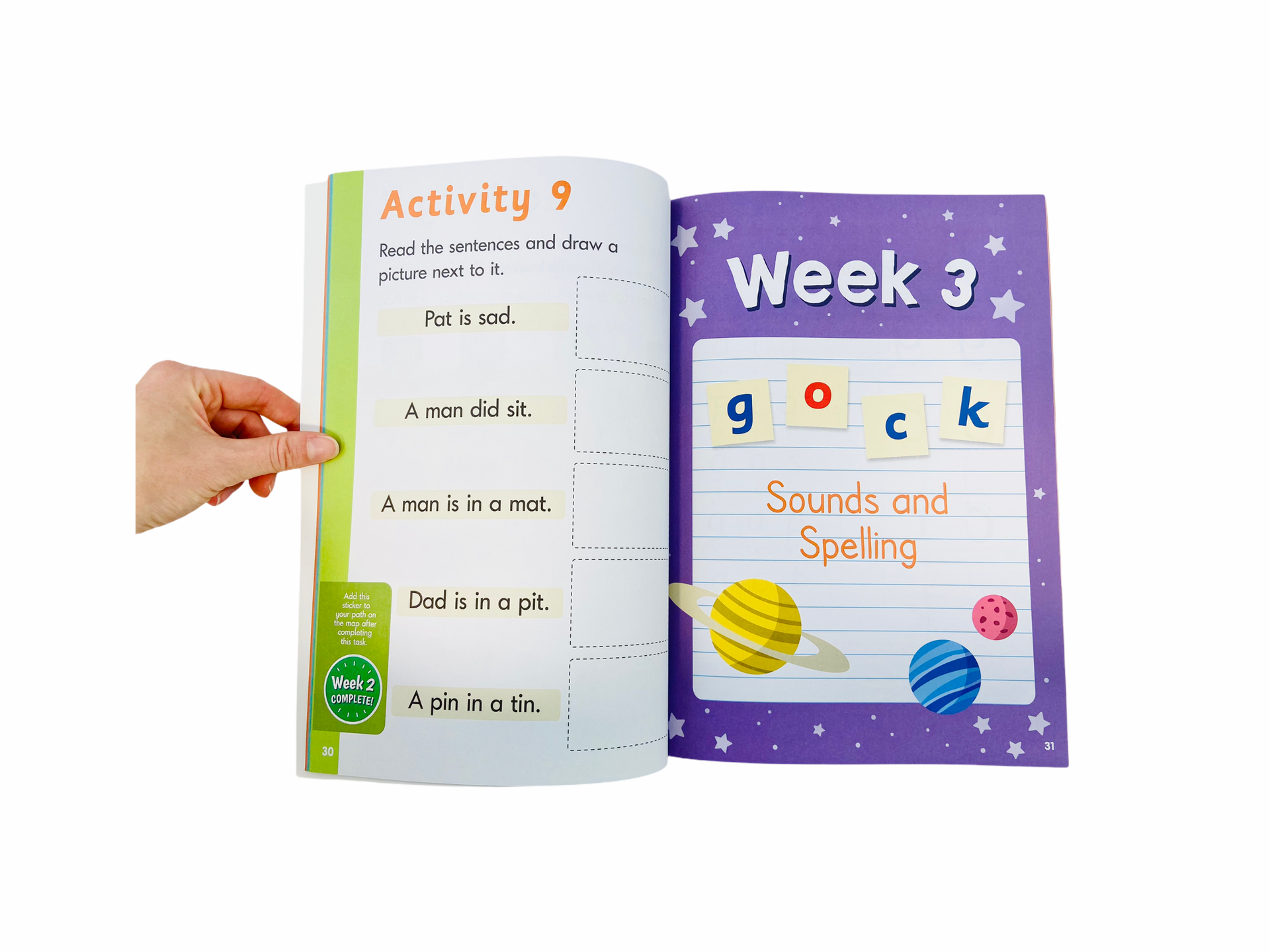 a hand turning a page from the Letter Sounds Workbook - Phase 2