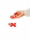 Hand holding 1 6 sided Vowels Dice on white background 