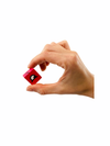 a hand holding a red cube from the Blue Orange Cubeez Game