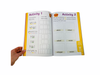 a hand turning the page from the Vowel Sounds Workbook - Phase 5
