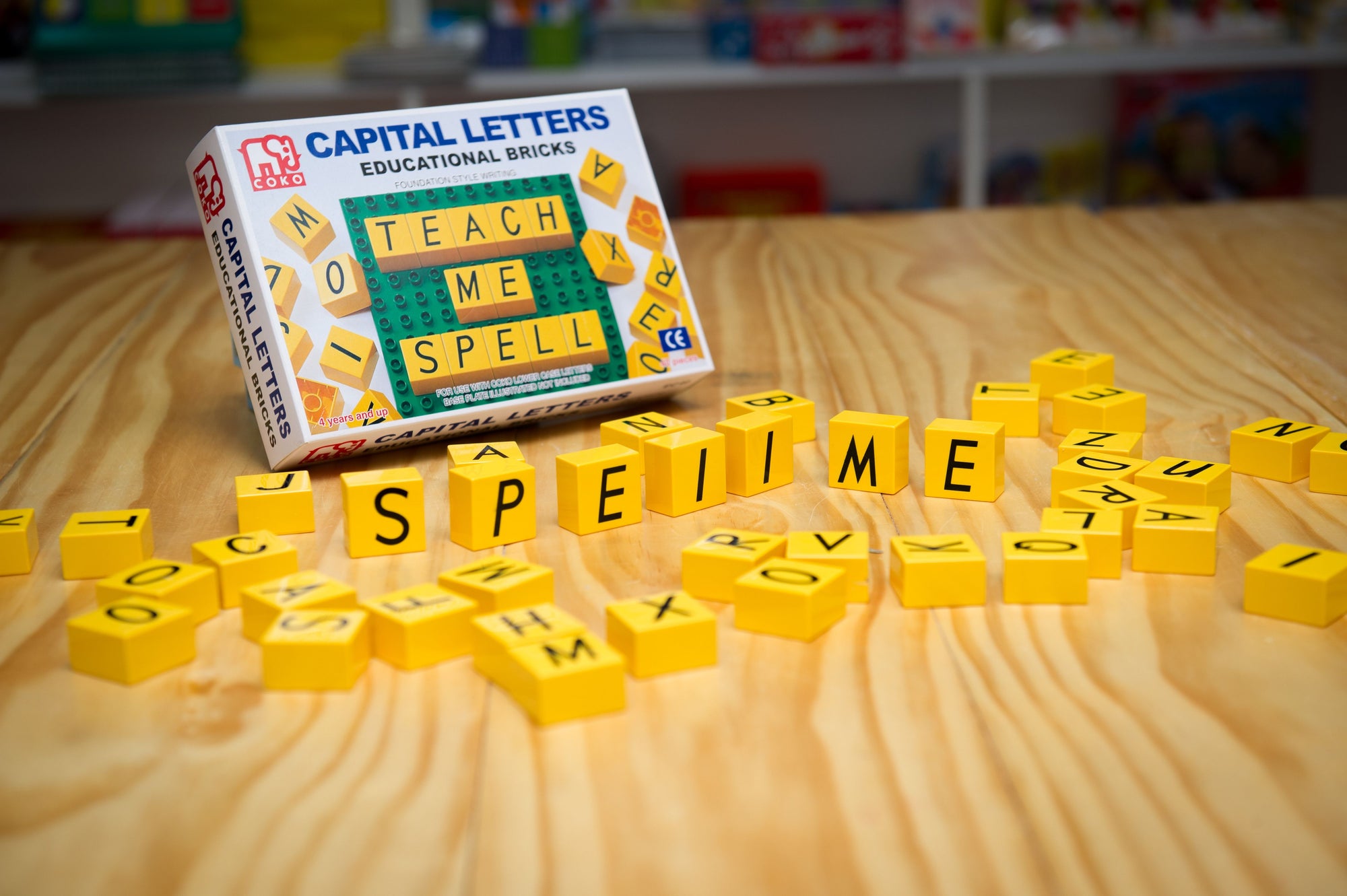 the Coko Bricks Upper Case Letters set on wooden table