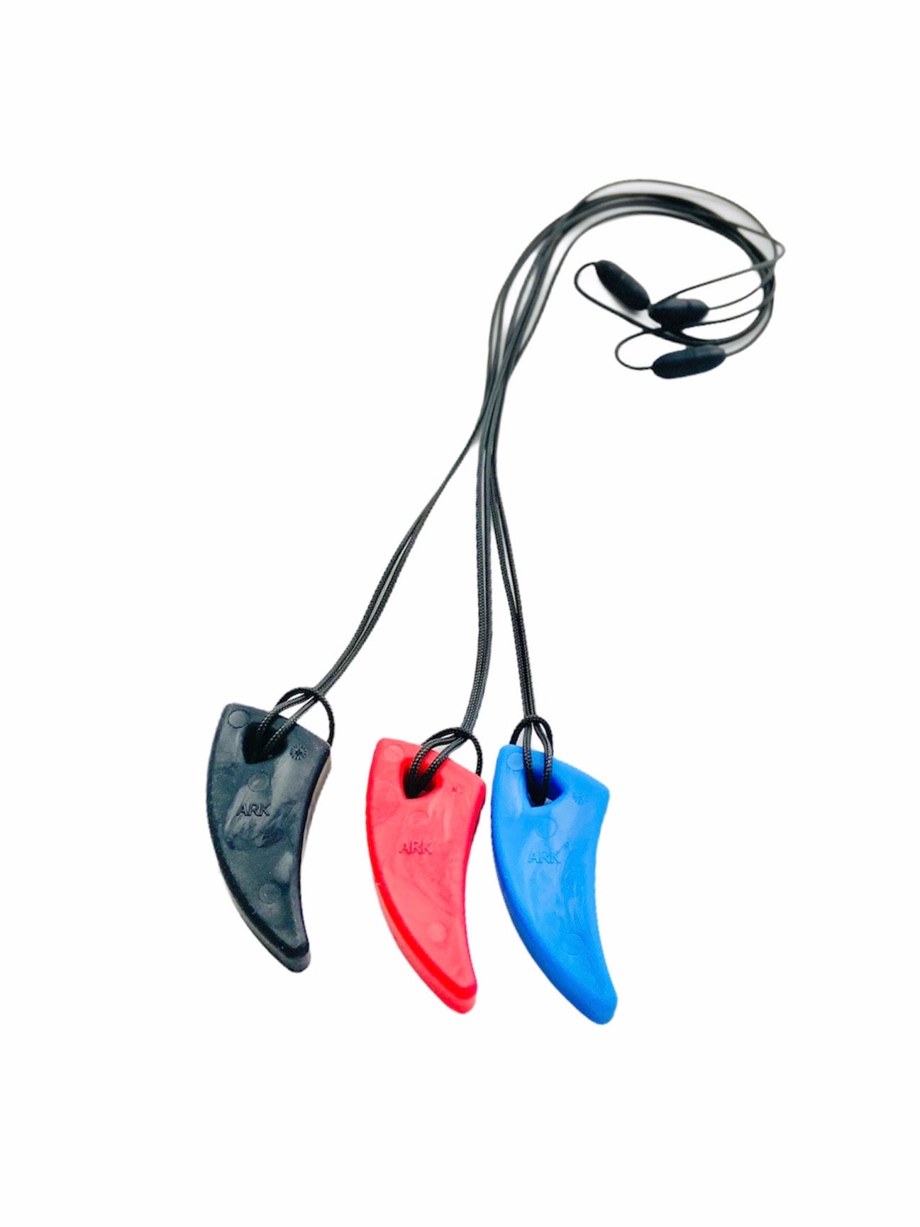 the black, red and bue Ark Saber Tooth Chews next to each other on a white background
