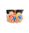 a person holding all 16 pastel balls from the Connetix Replacement Ball Pack - Pastel set
