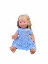 Down Syndrome Doll - Fair Skin/Blonde Hair Girl in sitting position wearing blue dress with her hand stretched out