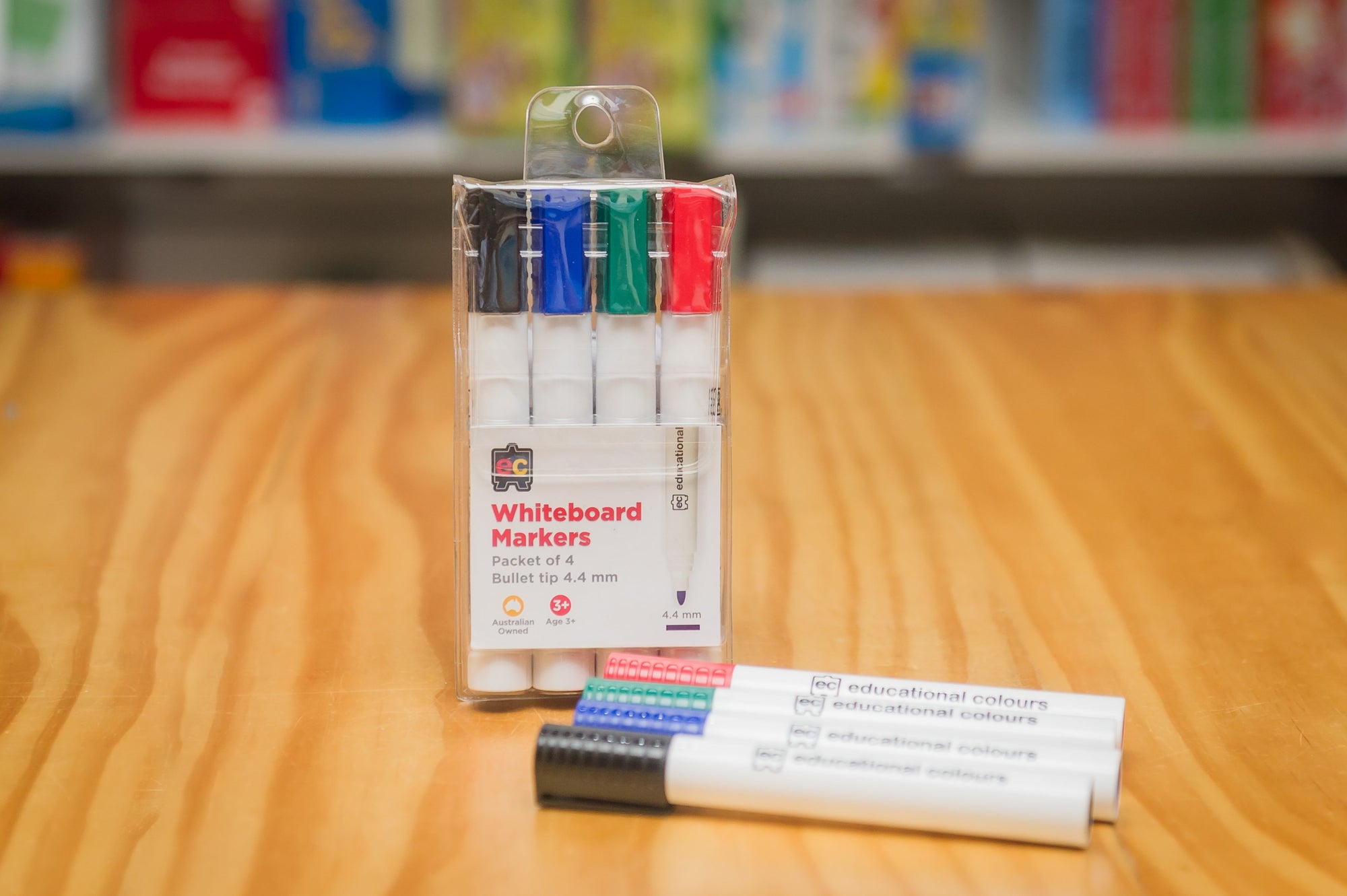 EC Whiteboard Markers in pastic storage wallet with pens placed on wooden table