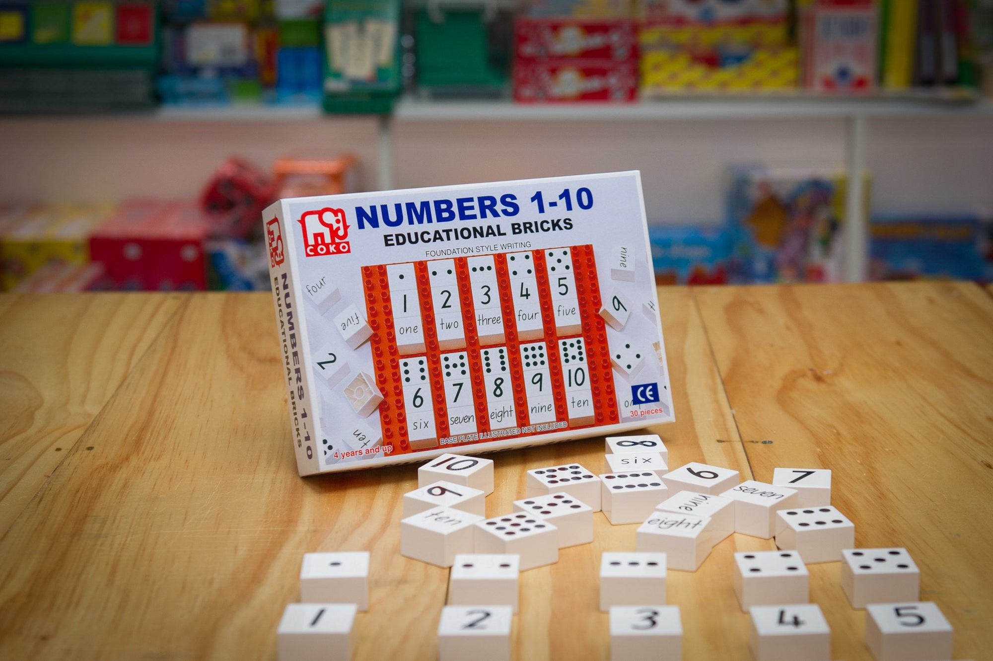 Coko Bricks Numbers 1-10 with numbered brick and packaging laid out on wooden table