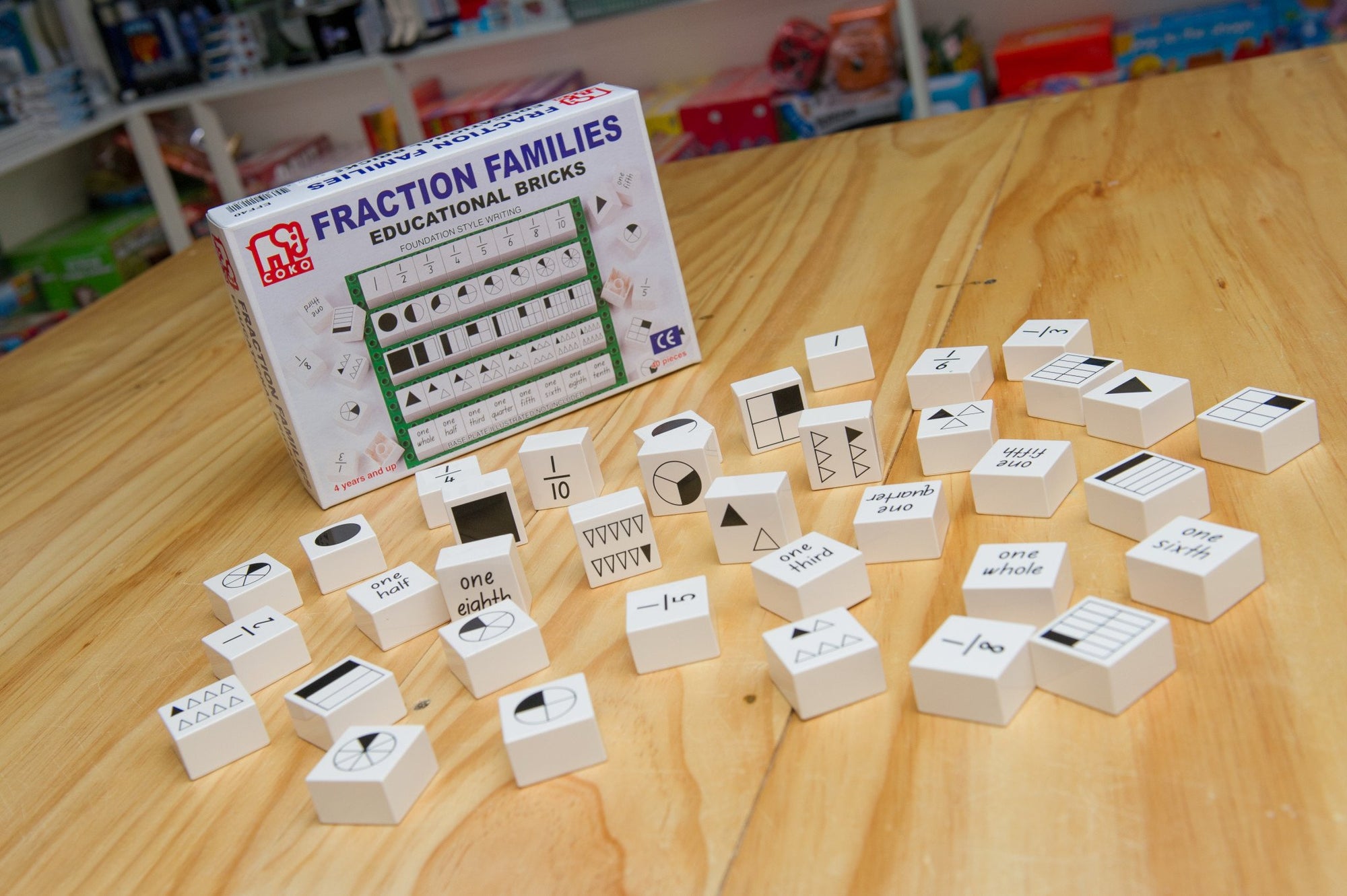 Coko Bricks Fraction Families with bricks and packaging laid out on wooden table