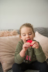 Young girl chewing on the plain flavoured red Chew Stixx Chew Lolli Knobby