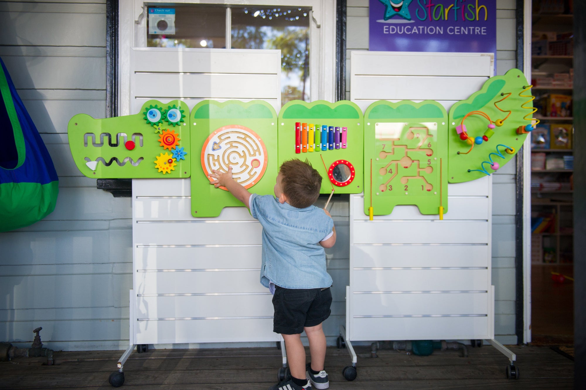 a child playing the Viga Interactive Wall Mural Crocodile