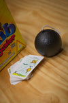 Pass The Bomb Junior bomb and cards on wooden table
