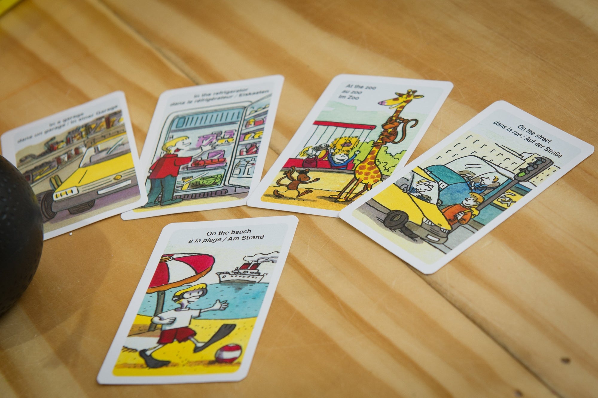 the cards from the Pass The Bomb Junior on wooden table