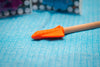 the orange Jellystone Chew Rocket Pencil Jumbo sitting on blue table