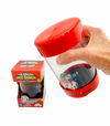 a hand holding the The Dancing Dice Shaker in front of box