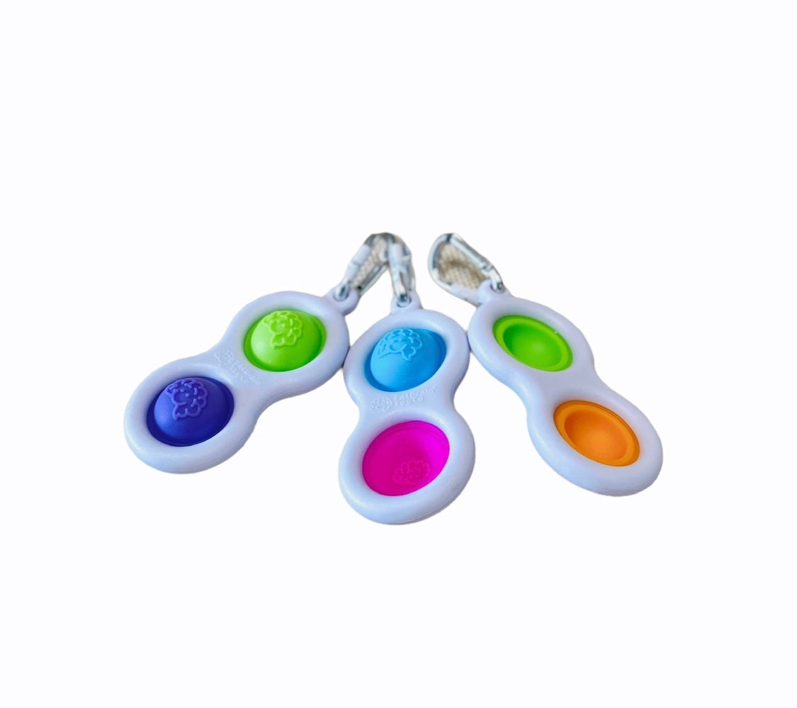 Fat Brain Simpl Dimpl Fidget in various different colours on white background