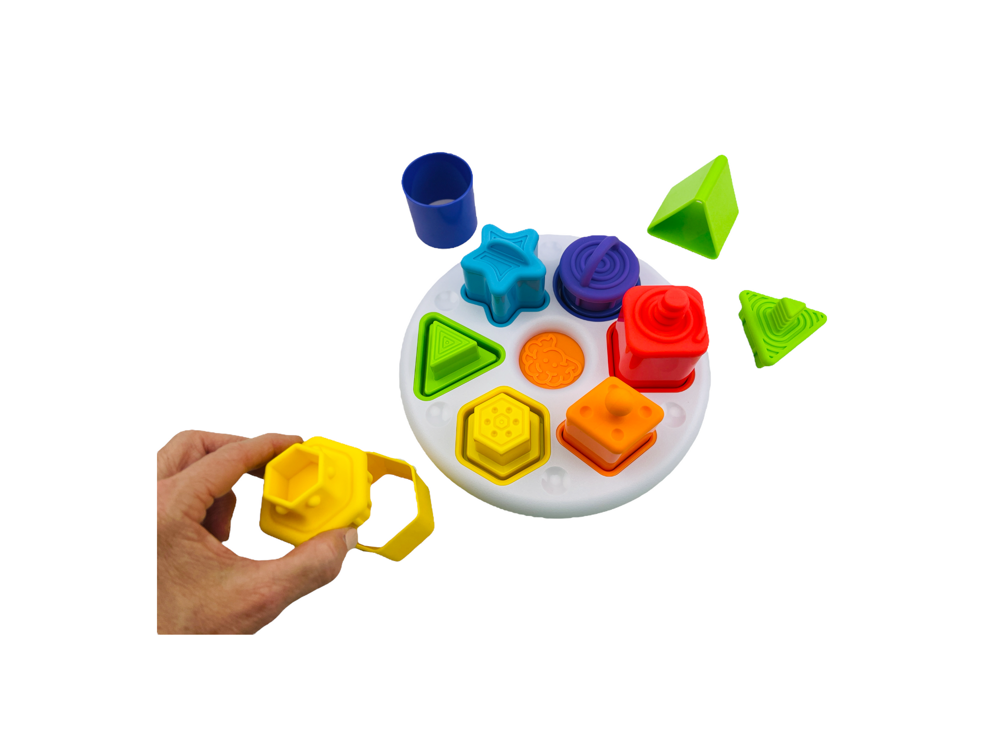 a hand holding the yellow piece from the Fat Brain Plugzy