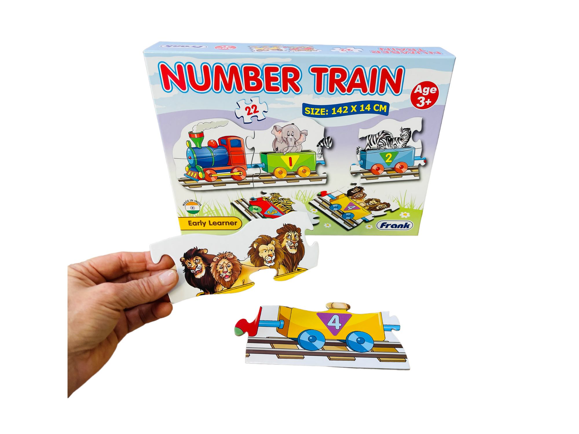 the Frank Early Learner Number Train on display with a hand holding a piece next to another in front of it&#39;s box