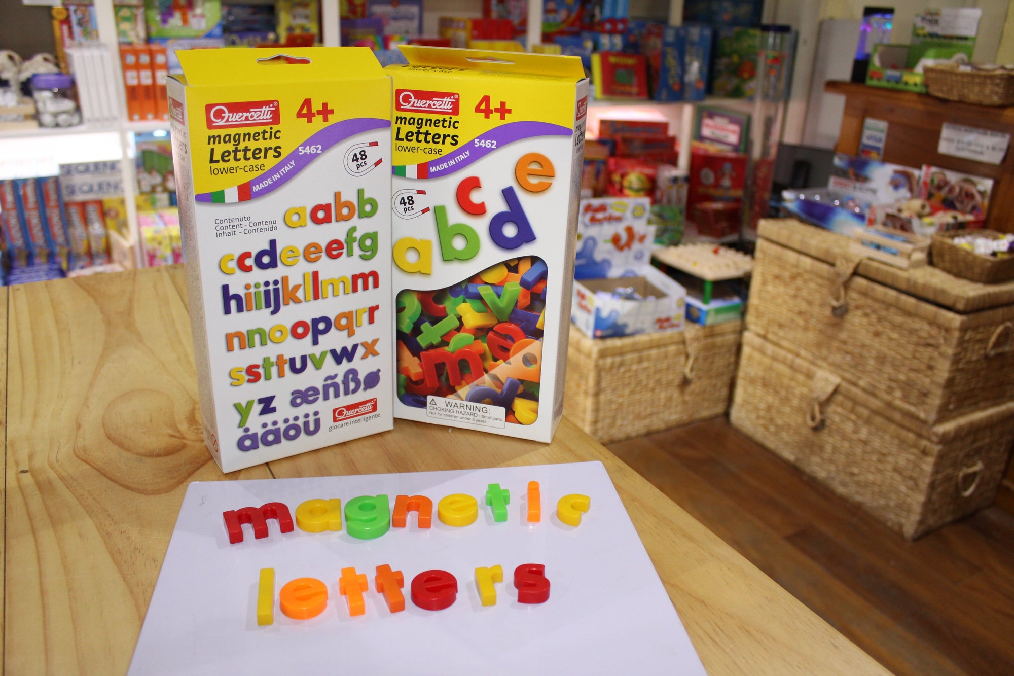 Quercetti Magnetic Lower-Case Letters on display with letters spelling &#39;magnetic letters on white magnetic surface