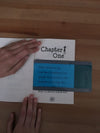 a person using the Large Highlight Strip Blue on an open book