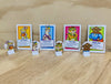the pieces from the Orchard Times Tables Heroes on wooden table and background